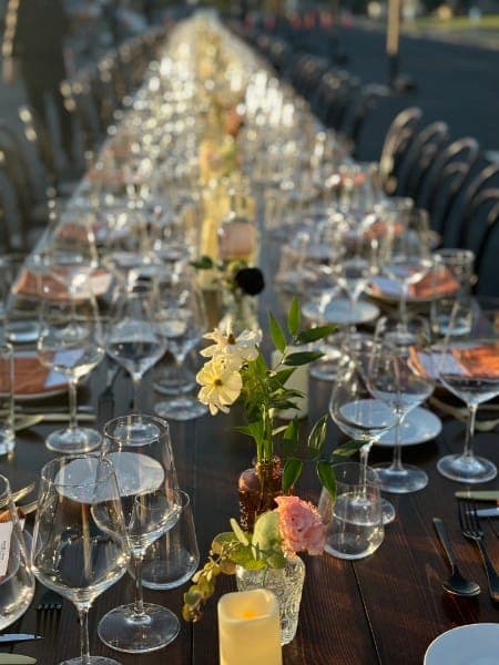 A long table set for a VinoCadre gathering at golden hour in the Texas Hill Country.