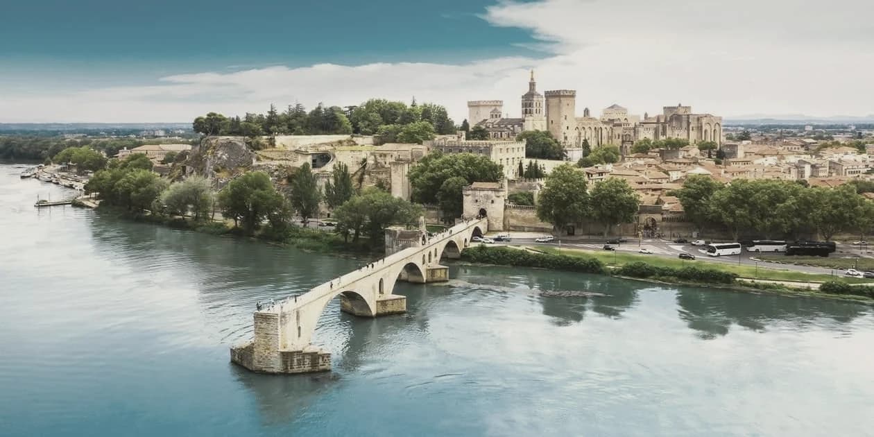 Avignon on the Rhône — the papal palace above the river and the remaining arches of the Pont d'Avignon.
